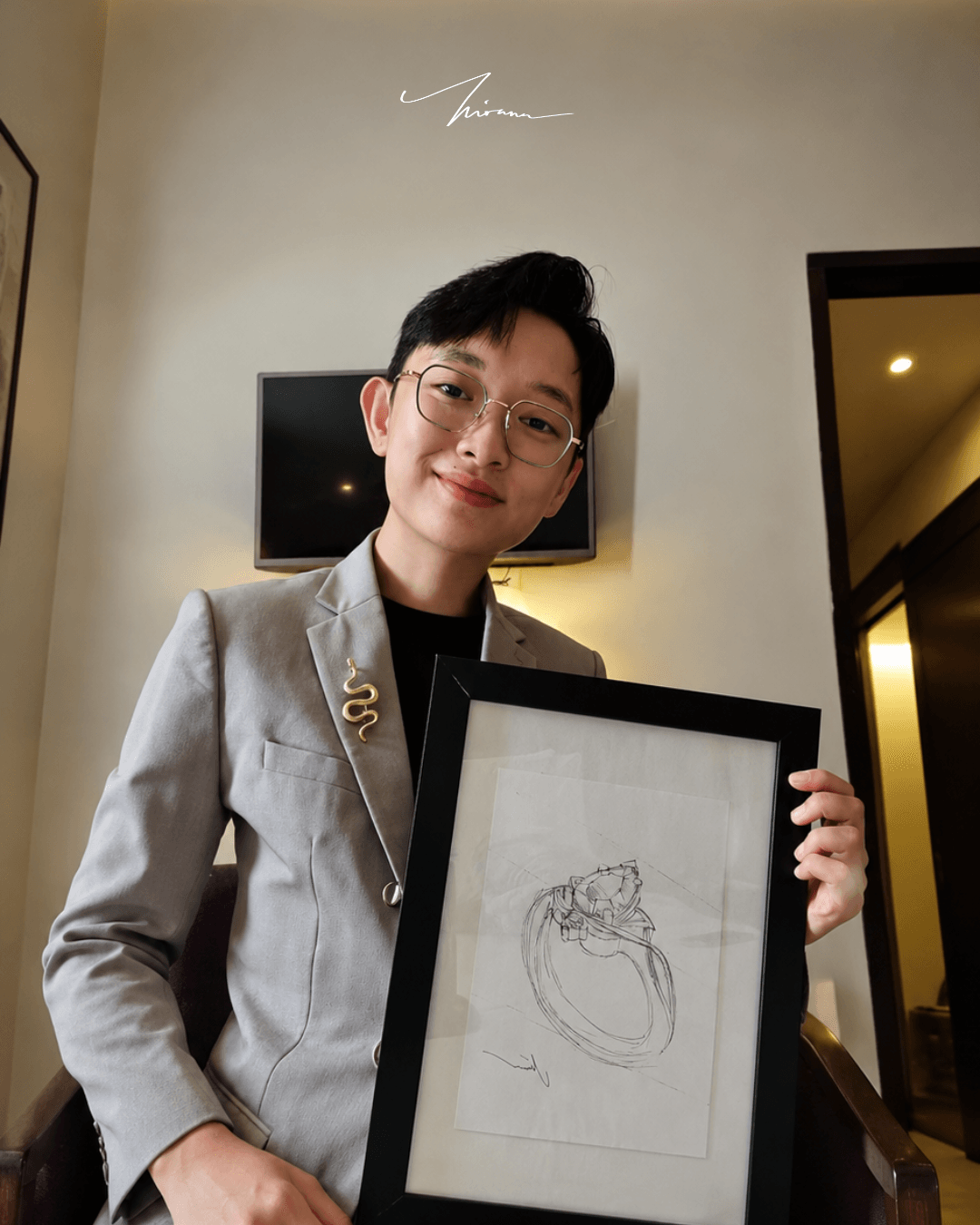 Kirana Private Atelier designer holding a ring sketch in a frame